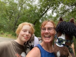 A younger female mentee and her adult female metnor with hobby horse.