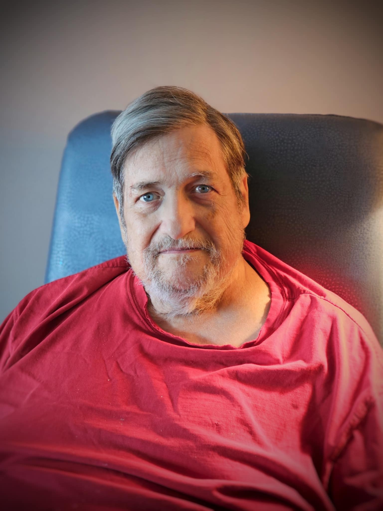 Senior man in a red shirt in his new apartment.