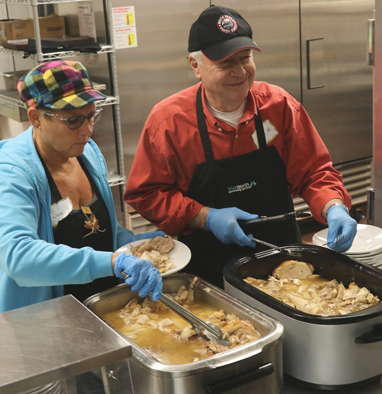Volunteers helping serve Thanksgiving dinner