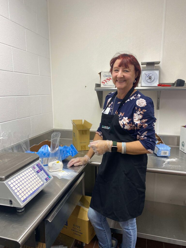 Woman helping repackage food.