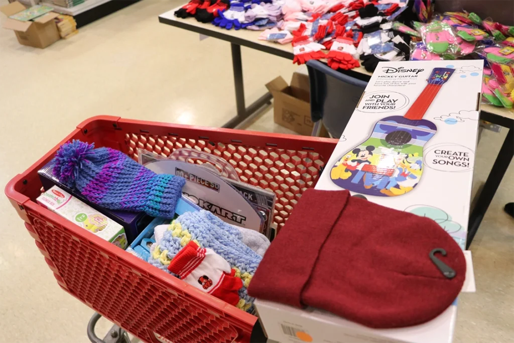 shopping cart with toys and winter accessories