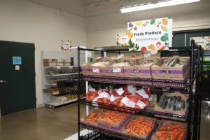 the interior of TrueNorth's Food Center; display racks of fresh produce- including carrots, cucumbers and potatoes