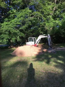An excavator clearing someone's yard.