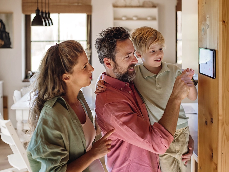 Family adjusting thermostat