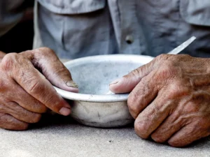 Two hands holding an empty bowl