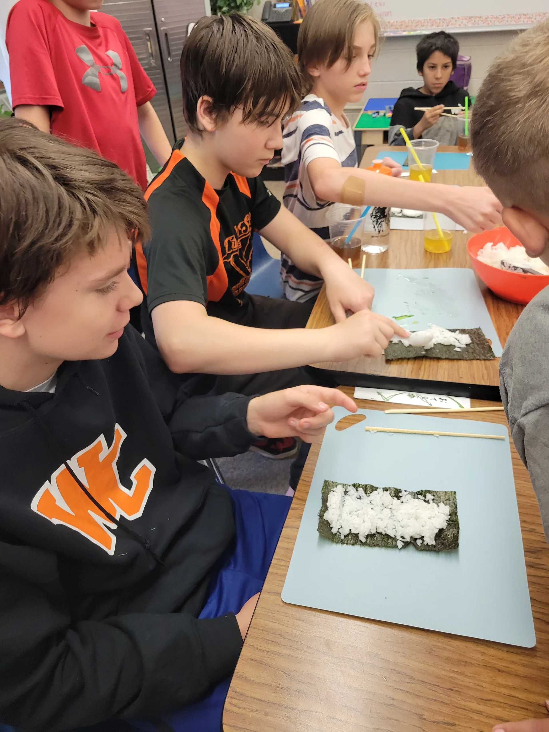 Several students learning to make sushi at Project FOCUS