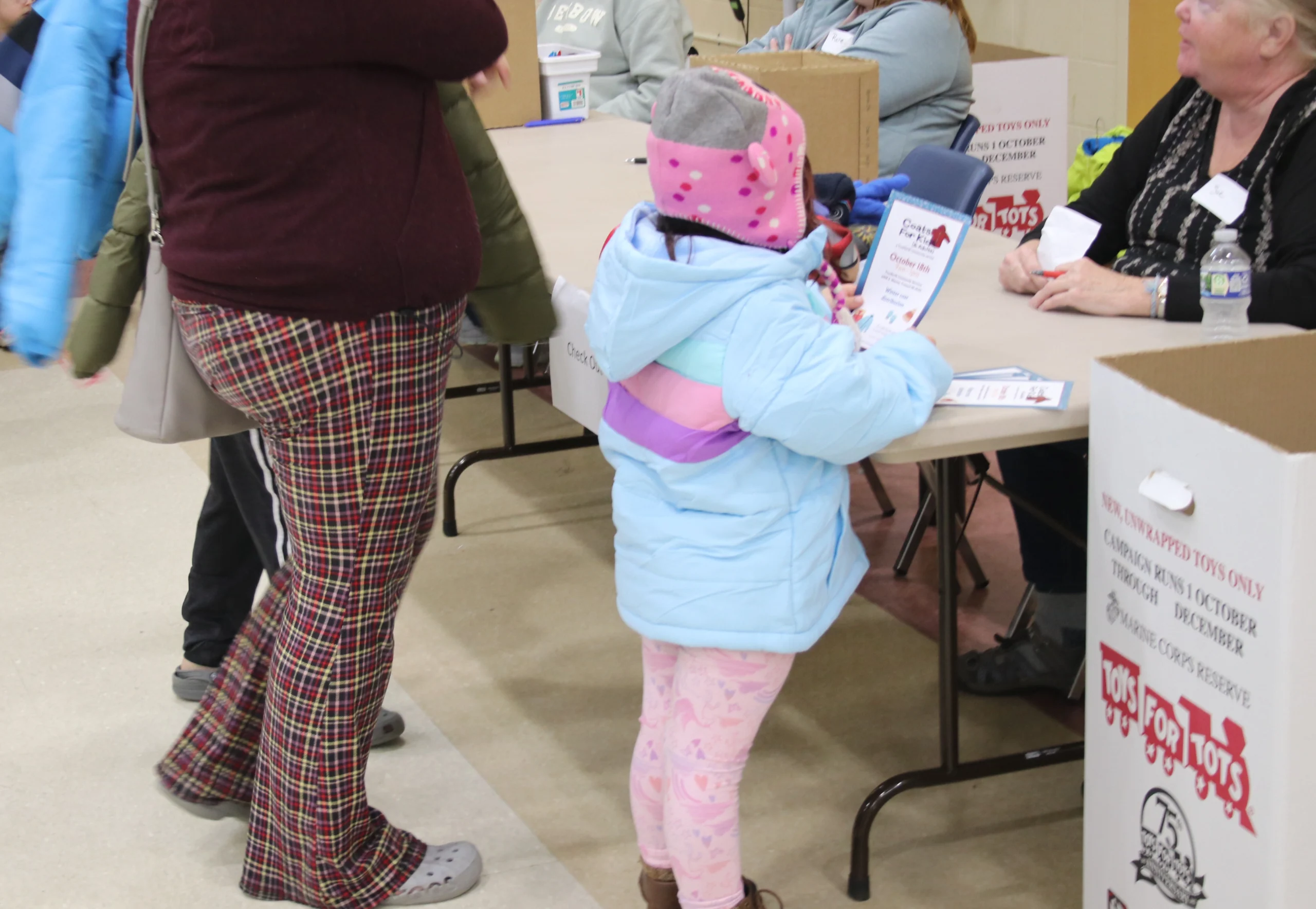 A little girl wearing her new coat at Coats at Kids (and Adults)
