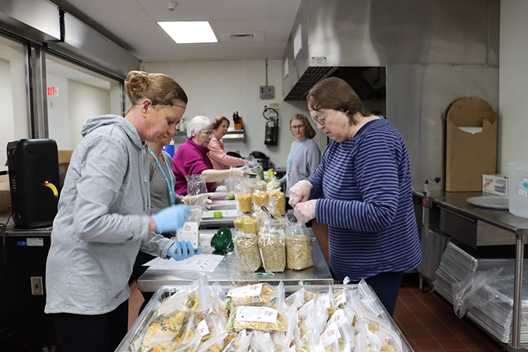 Volunteers packing food to go