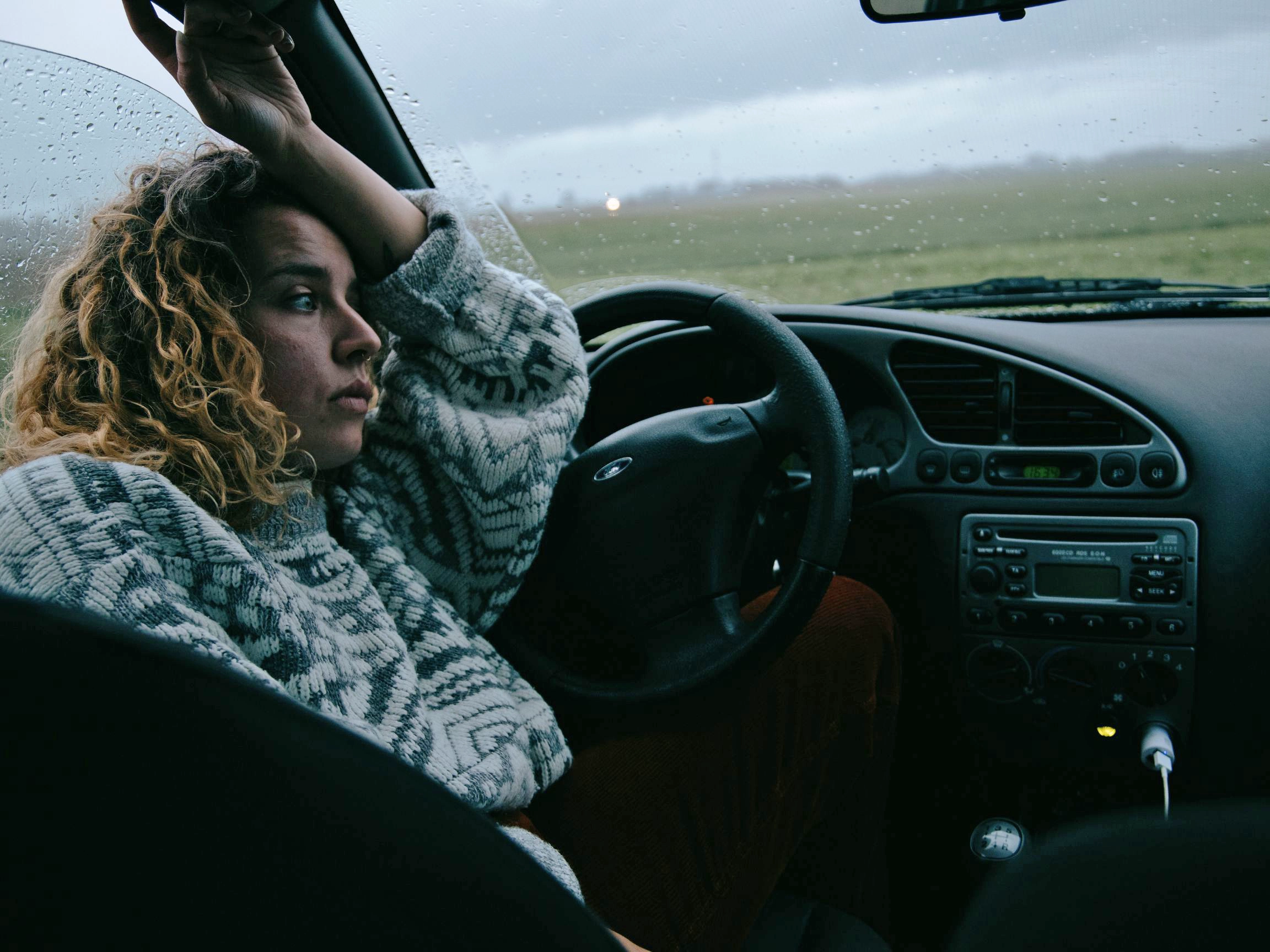 A sad-looking woman living in her car