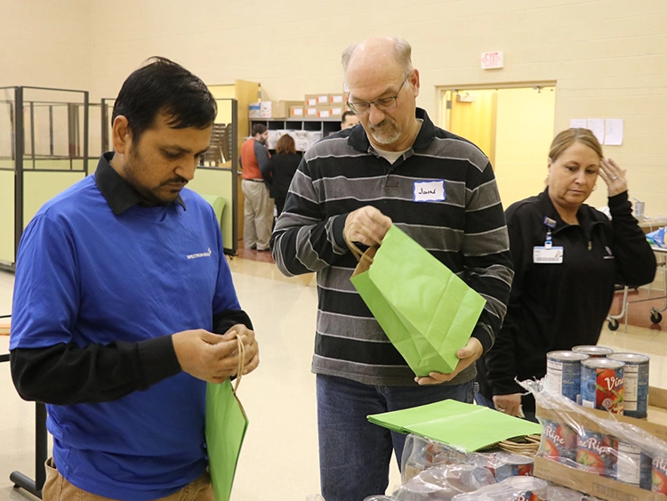 Volunteers packing bags with food.