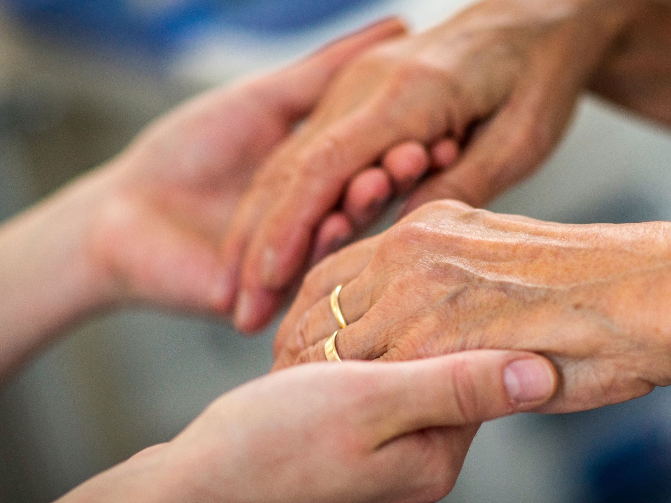 set of hands holding onto another set of hands