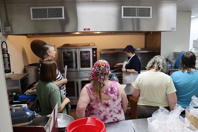 A group of Food Center members attend a workshop in the TrueNorth kitchen